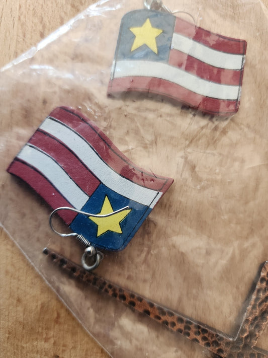 Wooden flag earrings and cross centerpiece of a necklace.