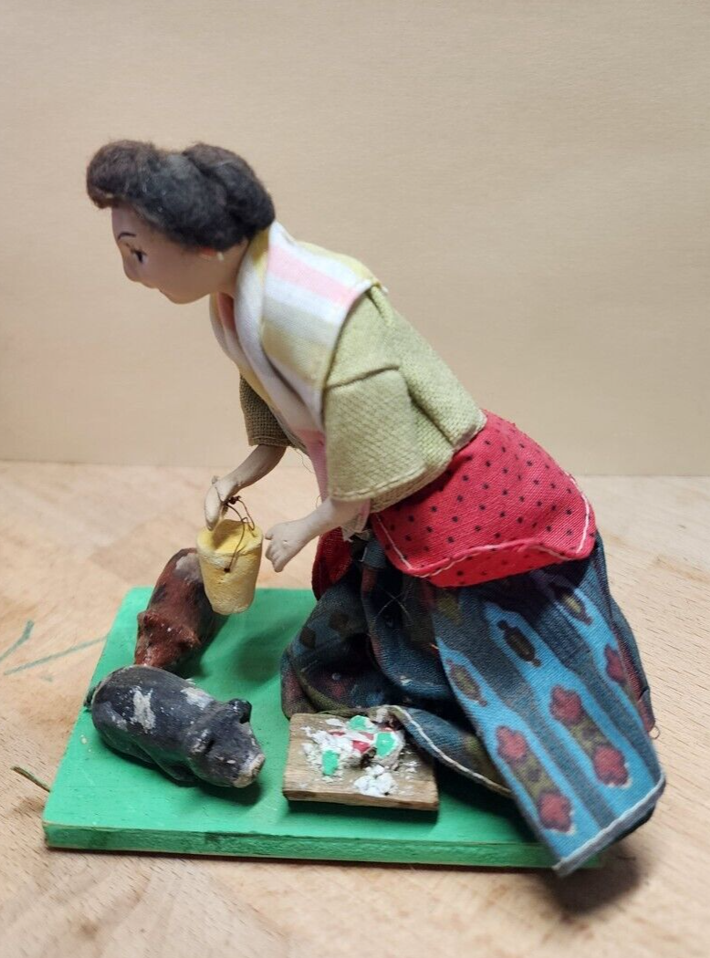 Vintage folk art doll feeding the pigs 4"